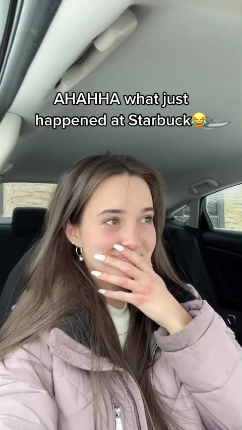 Twin in a car reacting to a Starbucks cup where the barista blacked out the warning label to read "Careful, you're extremely hot".