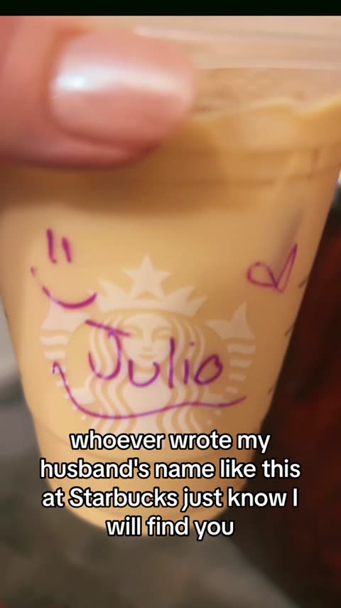 Close-up of iced Starbucks cup: name "Julio" in pink marker with smiley and heart; wife jokes she will find the barista.